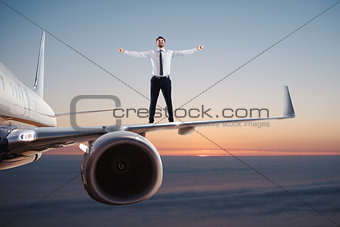 Businessman over an airplane swing. Concept of freedom