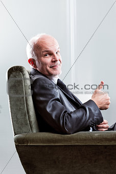 Satisfied happy businessman giving a thumbs up
