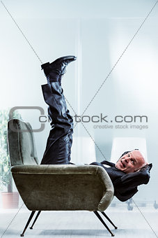 Fit businessman working out in his chair
