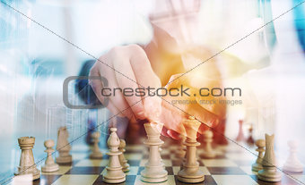 Business strategy with chess game and handshaking business person in office. concept of challenge and tactic. double exposure
