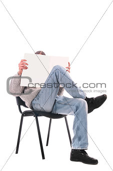 man in a chair with a magazine