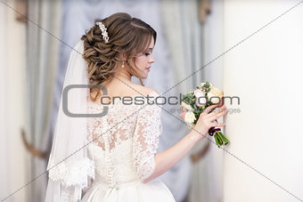 portrait of the bride on the window background