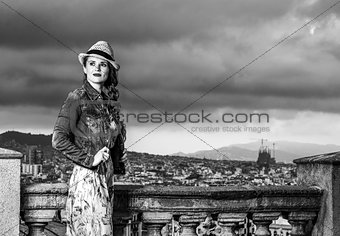 woman against city panorama of Barcelona looking into distance