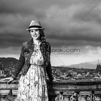smiling tourist woman against cityscape of Barcelona, Spain