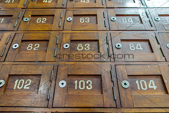 Old wooden Post Box with numbers selective focus Look from lower level