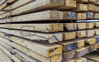 pile wide boards drying of construction materials with a perspective view of many beams