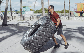 Man working out with tyre