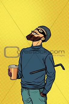 Robber thief hacker drinks coffee and looks up