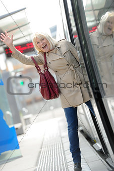 Senior Woman happy taking tram