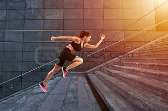 Girl runs fast on a modern stair