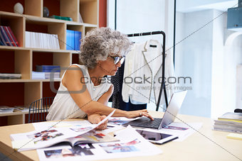Senior female media creative working on magazine layout