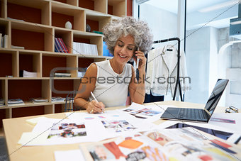 Senior female media creative working on the phone