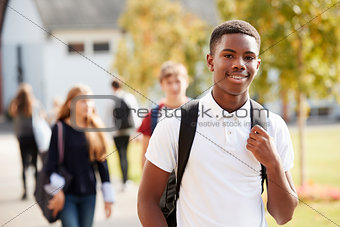 Portrait Of Male Teenage Student Walking Around College Campus