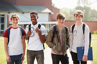 Portrait Of Male Teenage Students Walking Around College Campus