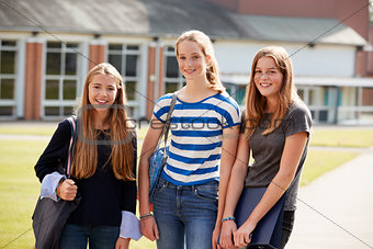 Group Of Female Teenage Students Walking Around College Campus