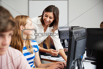 Teenage Students Studying In IT Class With Female Teacher