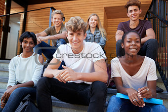 Group Of Teenage Students Socialising On College Campus Together