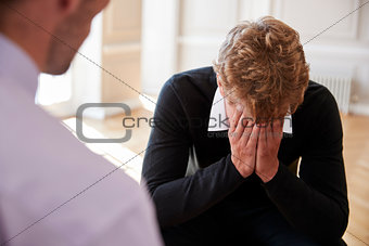 School Counselor Talking To Depressed Male Pupil