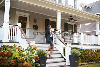 Businesswoman Leaving Suburban House For Commute To Work