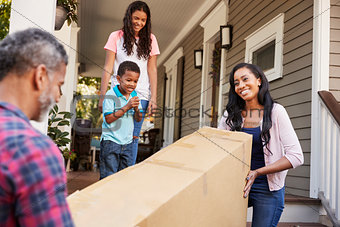 Family Carrying Big Box Purchase Into House
