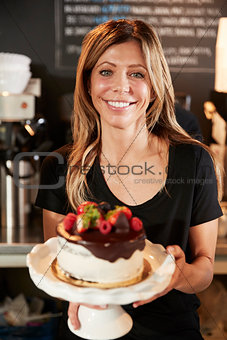 Waitress Holding Freshly Baked Cake With Buttercream Frosting