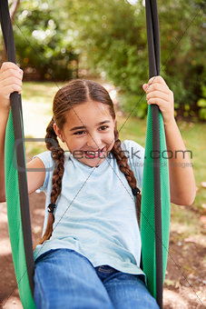 Girl Having Fun On Garden Swing At Home