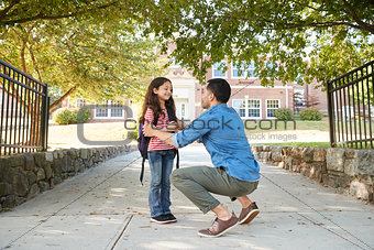 Father Dropping Off Daughter In Front Of School Gates