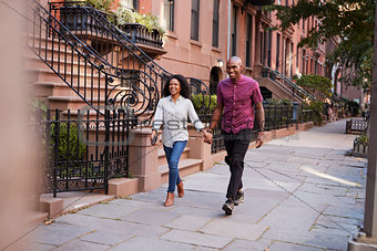 Young Couple Walking Along Urban Street In New York City