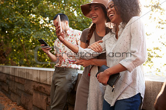 Group Of Tourists Taking Photos On Mobile Phones