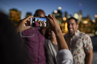 Group Of Friends Posing For Selfie In Front Of Manhattan Skyline