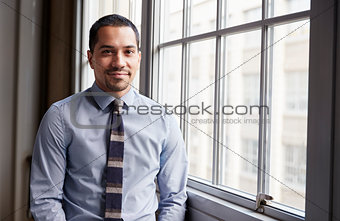 Young Hispanic business man smiling to camera