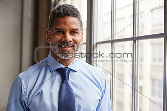 Middle aged black businessman smiling to camera