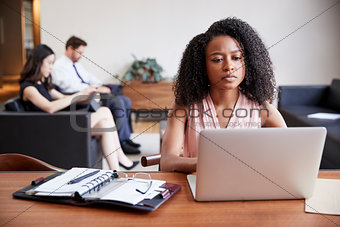 Young black businesswoman using laptop at a desk