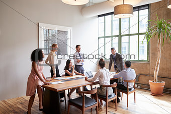 Young professionals around a table at a business meeting