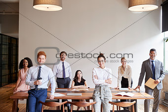 Young professionals at a business meeting looking to camera