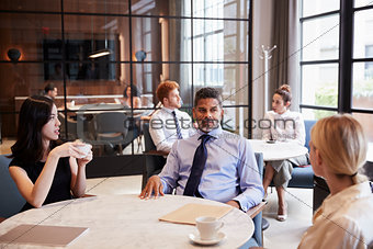 Business colleagues talking at their office cafe