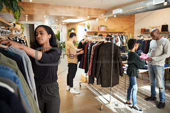 Customers and staff in a busy clothes shop