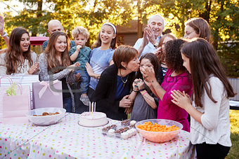 Friends and family gathered  at a garden birthday party