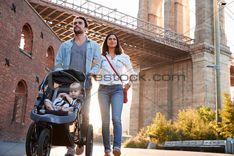Young family with a daughter taking walk on street, close up