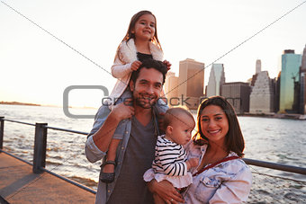 Young family with daughters standing on quayside, close up
