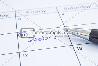 Doctor appointment date writing on calendar. 