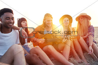 Happy group of friend having party on the beach