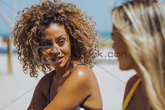 Beautiful women chatting on beach
