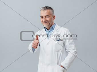 Cheerful doctor giving a thumbs up