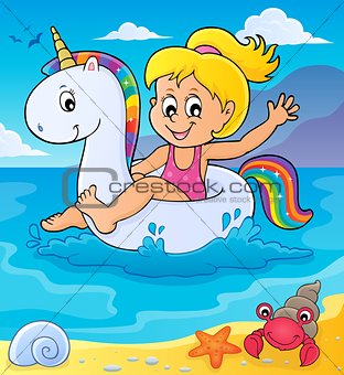 Girl floating on inflatable unicorn 2