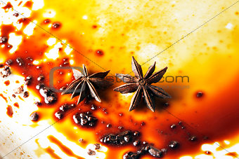 Asterisks anise on a plate with chocolate sauce