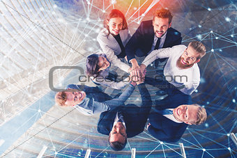 Business people putting their hands together with internet network effects. Concept of integration, teamwork and partnership. double exposure