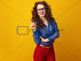 smiling modern woman in glasses got idea isolated on yellow