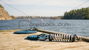 Marina wooden deck with blue sailing boat rope for yacht and docking.