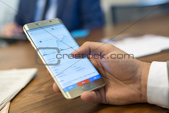 Close up of businessman using mobile smart phone.